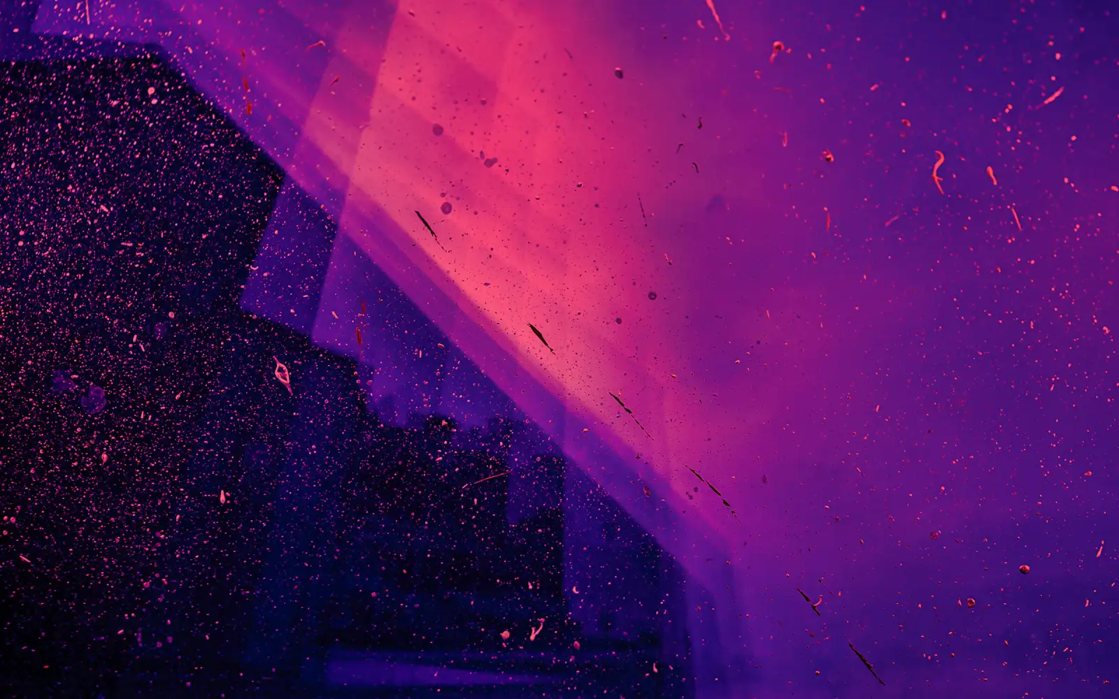 A diagonal shaft of pink light cutting through magenta and violet haze, with dust suspended in it